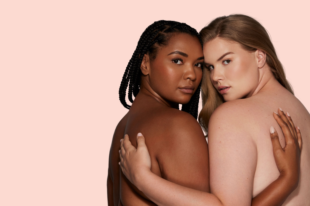 Two women hugging with clear skin